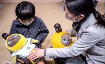  ??  ?? Photo shows diners interactin­g with robots Lovot in a cafe in Kawasaki, Japan.