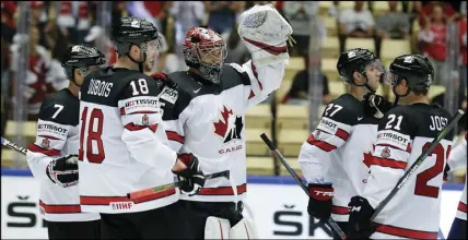  ?? AP PHOTO ?? Canadian goalie Darcy Kuemper, centre, celebrates with teammates after yesterday’s win against Germany.