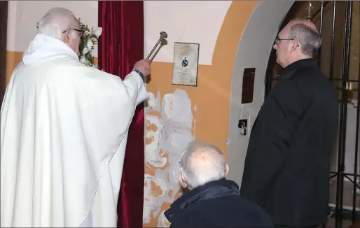  ??  ?? Fr. Jim Donleavy blesses the refurbishe­d shrine to St. Martin during mass at the Dominican Church on Friday.