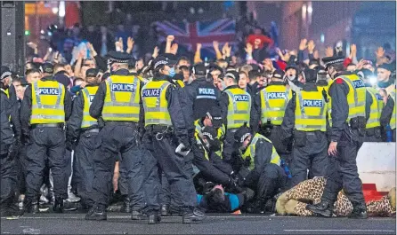  ?? Craig FOY/SNS ?? Police detain a man as Rangers fans gather at George Square in Glasgow on March 7
Picture: