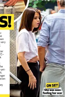  ??  ?? ON SET She was seen feeling her scar