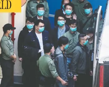  ?? VERNON YUEN / AFP VIA GETTY IMAGES ?? Hong Kong pro-democracy activists are escorted into a van as they leave the Lai Chi Kok Reception Centre,
the day after a gruelling session at West Kowloon Court ended with four being taken to hospital.