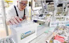  ?? — Reuters ?? A man tests Varta car battery at its plant in Stuttgart, Germany.