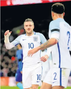  ??  ?? ■ Jamie Vardy celebrates his goal with Kyle Walker, but England lost out to their Dutch visitors at Wembley last night