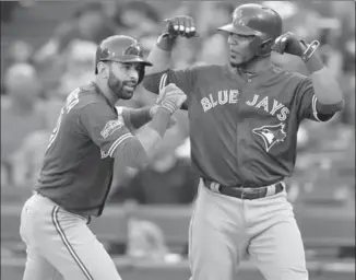  ?? KEVIN JAIRAJ, USA TODAY SPORTS ?? Blue Jays Jose Bautista, left, Edwin Encarnacio­n have forged their careers with the team, but chances are good at least one of them will not be back.