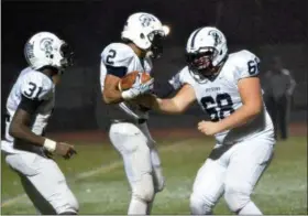  ?? THOMAS NASH - DIGITAL FIRST MEDIA ?? Pottstown lineman Cole Miller (68) joins the celebratio­n after Dereck Darden (2) scored a touchdown in the first half against Pottsgrove.