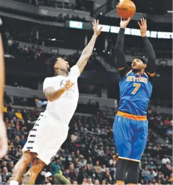  ?? David Zalubowski, The Associated Press ?? New York Knicks forward Carmelo Anthony, a former Nuggets star, tries to score against Nuggets forward Wilson Chandler during the first half of Saturday night’s game at the Pepsi Center.