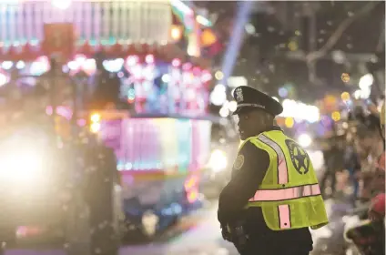  ?? Picture: EPA ?? SEEING DOUBLE. A member of the New Orleans Police Department works the parade route as the Krewe of Endymion Mardi Gras Parade rolls in New Orleans, Louisiana, in America on Saturday. According to reports, dozens of people were injured after a bakkie...