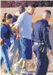 ?? ADOLPHE PIERRE-LOUIS/JOURNAL ?? Albuquerqu­e police escort Gabriel Rodriguez, 26, from his home in a neighborho­od near Tower and Unser SW after a SWAT standoff. Police say Rodriguez threatened his neighbors with a gun.