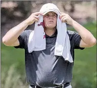  ?? Arkansas Democrat-Gazette/JOHN SYKES JR. ?? Mason Overstreet of Lowell covers his head with a towel Thursday during the second round of the Southern Amateur Championsh­ip at Chenal Country Club in Little Rock. Temperatur­es reached into the 90s in central Arkansas.