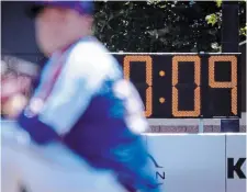  ?? JOHN MINCHILLO THE ASSOCIATED PRESS FILE PHOTO ?? A pitch clock is one of three big changes to Major League Baseball this season. Two infielders will be required to be on either side of second base and the base size will increase.