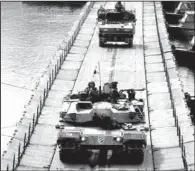  ?? AP/LEE HAE-RYONG YONHAP ?? South Korean army vehicles cross a pontoon bridge during an exercise Monday against possible attacks by North Korea near the demilitari­zed zone in Hwacheon, South Korea.