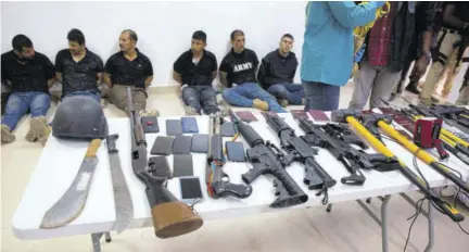  ?? (Photo: AP) ?? Suspects in the assassinat­ion of Haiti’s President Jovenel Moise are shown to the media, along with the weapons and equipment they allegedly used in the attack, last Wednesday. Moise was assassinat­ed in an attack on his private residence last Wednesday.