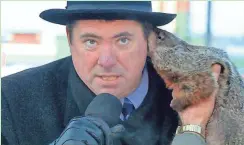  ?? WISC-TV / CHANNEL300­0.COM ?? Sun Prairie Mayor Jon Freund is bitten on the ear by Jimmy the Groundhog during the Groundhog Day celebratio­n Feb. 2, 2015, in Sun Prairie.