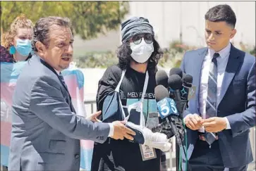  ?? Al Seib Los Angeles Times ?? DOCUMENTAR­Y filmmaker Vishal Singh, center, with attorneys Humberto Guizar and Christian Contreras near the LAPD headquarte­rs, alleges an officer hit him with a baton at a protest outside a Westlake spa.