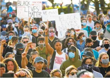  ?? K.C. ALFRED U-T FILE ?? Protesters take to the streets May 31 after George Floyd’s death. Reforms came quickly in San Diego, and activists say while positive, they don’t address the base level of how police interact with the community.