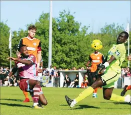  ??  ?? FACE OFF: Gabby Odunaike sees his close-range effort blocked by Denzel Gerra in the play-off final against Walton Casuals