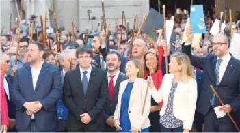  ?? — Reuters ?? Catalan regional President Carles Puigdemont followed by mayors of towns of Catalonia that support the Referendum of 1-O arrive at Palau de la Generalita­t in Barcelona on Saturday.