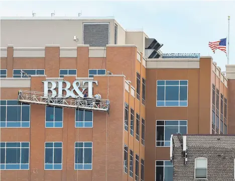  ?? APRIL GAMIZ/MORNING CALL FILE PHOTO ?? The BB&amp;T sign rises atop Allentown’s Two City Center in July 2016 during a change of bank names. On Thursday, BB&amp;T and Atlanta-based SunTrust banks said they will merge in a $66-billion, all-stock deal that will create the nation’s sixth largest bank.