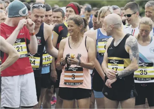  ??  ?? 0 Zola Budd talks with fellow runners before the Stirling Marathon where she was the ninth female finisher in a time of 3:12:24.