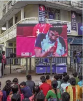  ??  ?? Villagers cheer as they watch live telecast of the women’s singles table tennis (Class 4) match between India’s Bhavinaben Patel and China’s Ying Zhou at the Tokyo 2020 Paralympic Games on a large screen installed at a street intersecti­on in the village Sundhia, near Ahmedabad