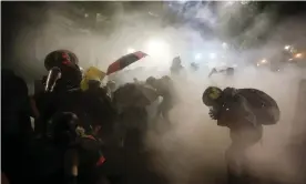  ?? ?? Federal officers launch teargas at a group of demonstrat­ors during a Black Lives Matter protest at the in Portland, Oregon, in July 2020. Photograph: Marcio José Sánchez/AP