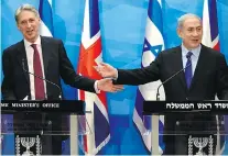  ?? DEBBIE HILL/AFP/Getty Images ?? British Foreign Secretary Philip Hammond holds a press conference with Israeli Prime Minister Benjamin Netanyahu.