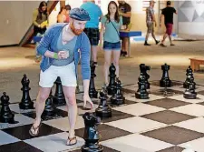  ??  ?? A guest plays chess in Big Game Theory during SMO 21 at Science Museum Oklahoma’s adults-only night.