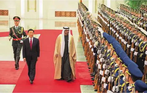  ?? WAM ?? Shaikh Mohammad Bin Zayed inspects the guard of honour with Li Yuanchao, Vice-President of China, at the Great Hall of the People in Beijing. They discussed ways to bolster cooperatio­n in various avenues.