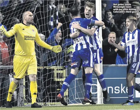  ??  ?? Net gains: Jamie McGonigle roars with joy after hitting Coleraine’s third goal