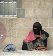  ?? — AP ?? A displaced Yemeni woman and her child, who fled their home by the fighting the port city of Hodeida, sit in a school in Sanaa, Yemen.