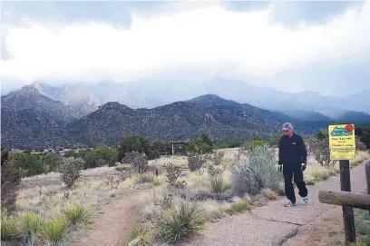  ?? ADOLPHE PIERRE-LOUIS/JOURNAL ?? Charles Winters of Park City, Utah, takes a winter hike on the Pino Trail in the Sandia Mountains in 2016.