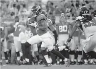  ?? AP Photo/Phelan M. Ebenhack ?? ■ Jacksonvil­le Jaguars wide receiver Donte Moncrief (10) runs after catching a pass between Atlanta Falcons cornerback Isaiah Oliver (20) and linebacker De’Vondre Campbell (59) on Aug. 25 in Jacksonvil­le, Fla. Moncrief might be Jacksonvil­le’s go-to receiver heading into the season opener at the New York Giants. Moncrief certainly is the unwitting leader of that position group and will be counted on to fill a void created after Marqise Lee hurt his left knee in the preseason and was placed on injured reserve.