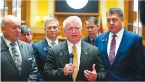  ?? AP FILE PHOTO/JOHN AMIS ?? State Sen. Randy Robertson, R-Cataula, center, is flanked by Majority Leader Mike Dugan, R-Carrollton, left, and Majority Whip Steve Gooch, R-Dahlonega, right, as he speaks to reporters in Atlanta. Robertson, a former police officer, introduced legislatio­n that would increase penalties for people who commit crimes during protests. The measure failed.