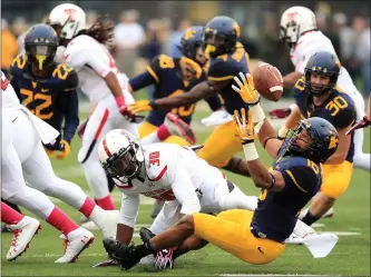  ?? CHRISTOPHE­R JACKSON - ASSOCIATED PRESS FILE ?? West Virginia’s Terrell Chestnut (16) forces a fumble on a kickoff return from Texas Tech’s Austin Stewart (30) during the second quarter of their NCAA football game in Morgantown, W.Va., on Oct. 19, 2013.