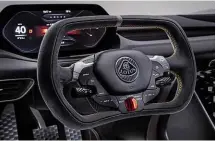  ??  ?? Multifunct­ion wheel and digital dash give cabin a race car feel. Floating console (below) features hexagonal buttons