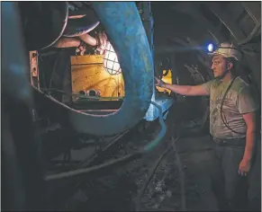  ??  ?? A Bosnian coal miner works in an undergroun­d tunnel.