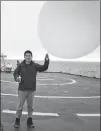  ?? PHOTOS PROVIDED TO CHINA DAILY ?? Zhang Peng, a post-doctoral researcher from the Institute of Atmospheri­c Sciences at Fudan University in Shanghai, releases a radiosonde balloon.