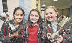 ??  ?? Peterborou­gh School pupils Evie Jones-Molynenx, Maddolena Chiarizia and Zunera Fatima with their trophies