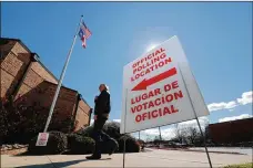  ?? LMOTERO/AP ?? Asignpoint­s potential voters to an official polling location in Dallas on Feb. 26. The virus’ disproport­ionate impact on Latinos hasmade recruiting Spanishspe­akers towork the pollsmore difficult.