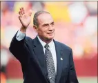  ?? Patrick McDermott / TNS ?? Hall of Famer Sam Huff waves to the crowd after being honored during a 2012 game between James Madison and West Virginia.