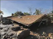  ?? MIKE ELIASON / SANTA BARBARA COUNTY FIRE DEPARTMENT ?? Mud, boulders and debris reached the roof of this house in Montecito, Calif., on Wednesday. Heavy rains caused deadly mudslides in fire-scarred areas of the city and county.