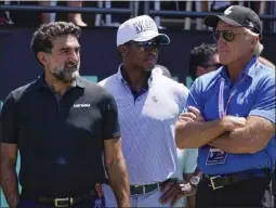  ?? SETH WENIG – THE ASSOCIATED PRESS FILE PHOTO ?? Yasir Al-Rumayyan, left, governor of Saudi Arabia's Public Investment Fund, Majed Al-Sorour, CEO of Golf Saudi, center, and Greg Norman, CEO of LIV Golf, watch the action during an LIV Golf tournament last July in Bedminster, N.J.