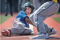  ?? JIM WEBER/THE NEW MEXICAN ?? Santa Fe All Stars’ Seth Cordova beats the tag at home to score during Friday’s game against Clovis in the first round of the Little League state tournament.