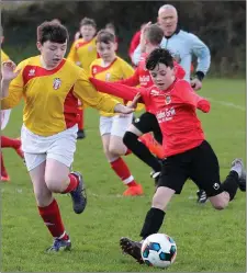  ??  ?? Dylan Lennon of New Ross Celtic under pressure from Kyle Delaney (Moyne Rangers) in their drawn Under-13 league encounter.