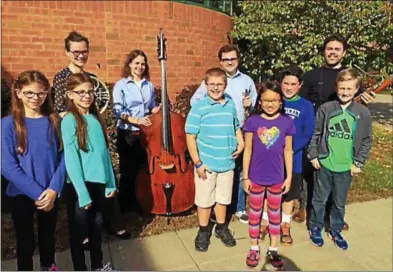  ?? PAUL POST — PPOST@DIGITALFIR­STMEDIA.COM ?? Maple Avenue Middle School students, in front, were mentored Friday by members of a Carnegie Hall fellowship program called Ensemble Connect. Post-graduate musicians spent a week-long residency at Skidmore College that included community outreach....
