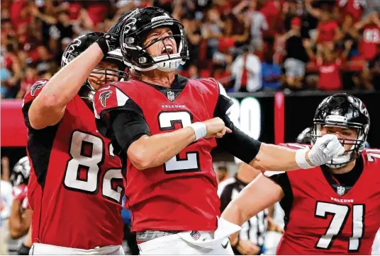  ?? CURTIS COMPTON / CCOMPTON@AJC.COM ?? Falcons QB Matt Ryan exults after scoring Sunday’s game-winning fourth-quarter touchdown against the Carolina Panthers in Atlanta. He scored two rushing TDs for the first time as a pro and completed 23 of 28 passes for 272 yards. Offensive coordinato­r Steve Sarkisian “did a great job of calling plays,” Ryan said.