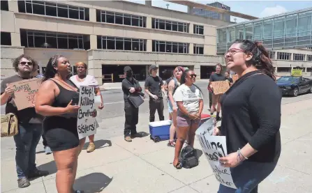  ?? PHOTOS BY KAREN SCHIELY/AKRON BEACON JOURNAL ?? Cristhy Sotres, right, of Akron, leads a chant during a protest in front of the Akron Police Department at the Harold K. Stubbs Justice Center Friday afternoon in downtown Akron.