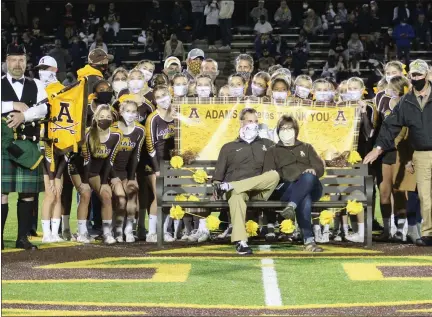  ?? COURTESY PHOTO ?? Rochester Adams athletic director Jason Rapp and his wife Susan sit together on a bench during a halftime ceremony during the Stoney Creek at Adams football game on Oct. 9. Rapp was being honored for his 24 years on the job. He retired from the AD position on Nov. 6.