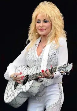  ??  ?? KEEPIN’ IT COUNTRY: Dolly can strum a guitar, but what of her reclusive man?